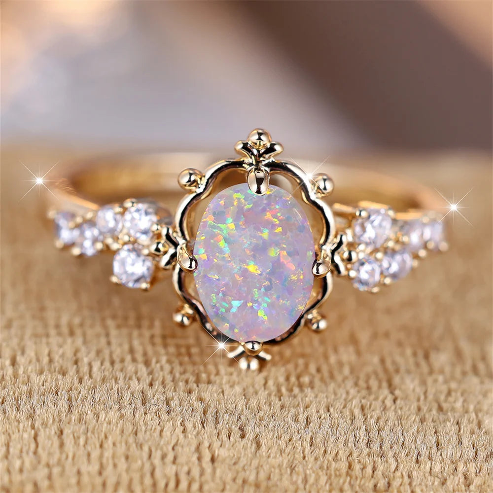 “White Fire Opal Oval Blossom Ring – Gold Filled Elegance”
A luminous White Fire Opal, glowing with shifting rainbows, rests at the heart of a delicate golden Blossom. Its oval cut catches the light with every movement,