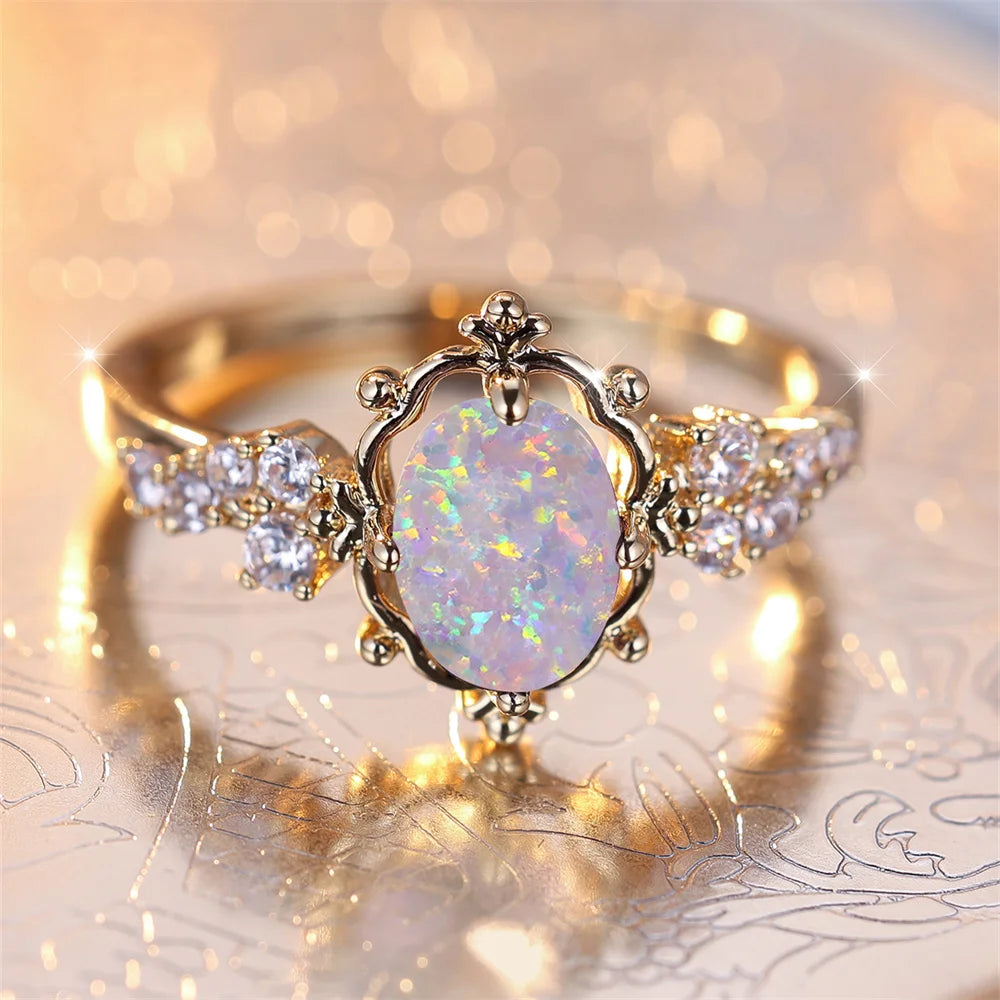 “White Fire Opal Oval Blossom Ring – Gold Filled Elegance”
A luminous White Fire Opal, glowing with shifting rainbows, rests at the heart of a delicate golden Blossom. Its oval cut catches the light with every movement,